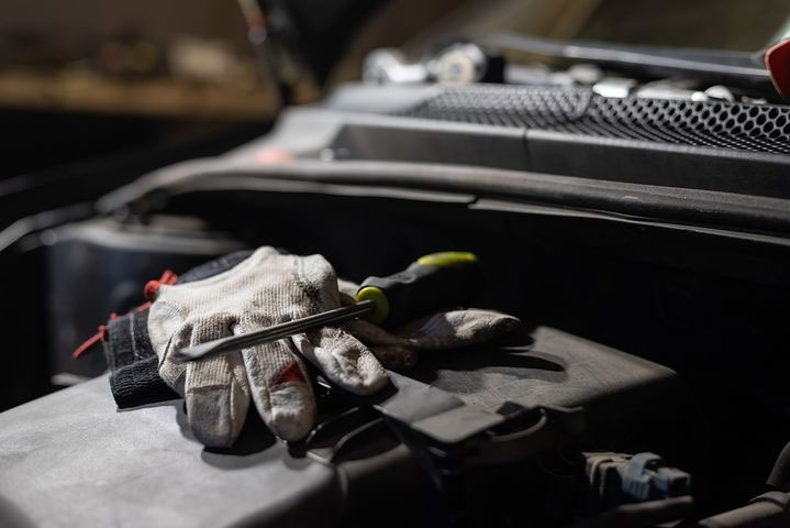 car engine photo with gloves and screw driver